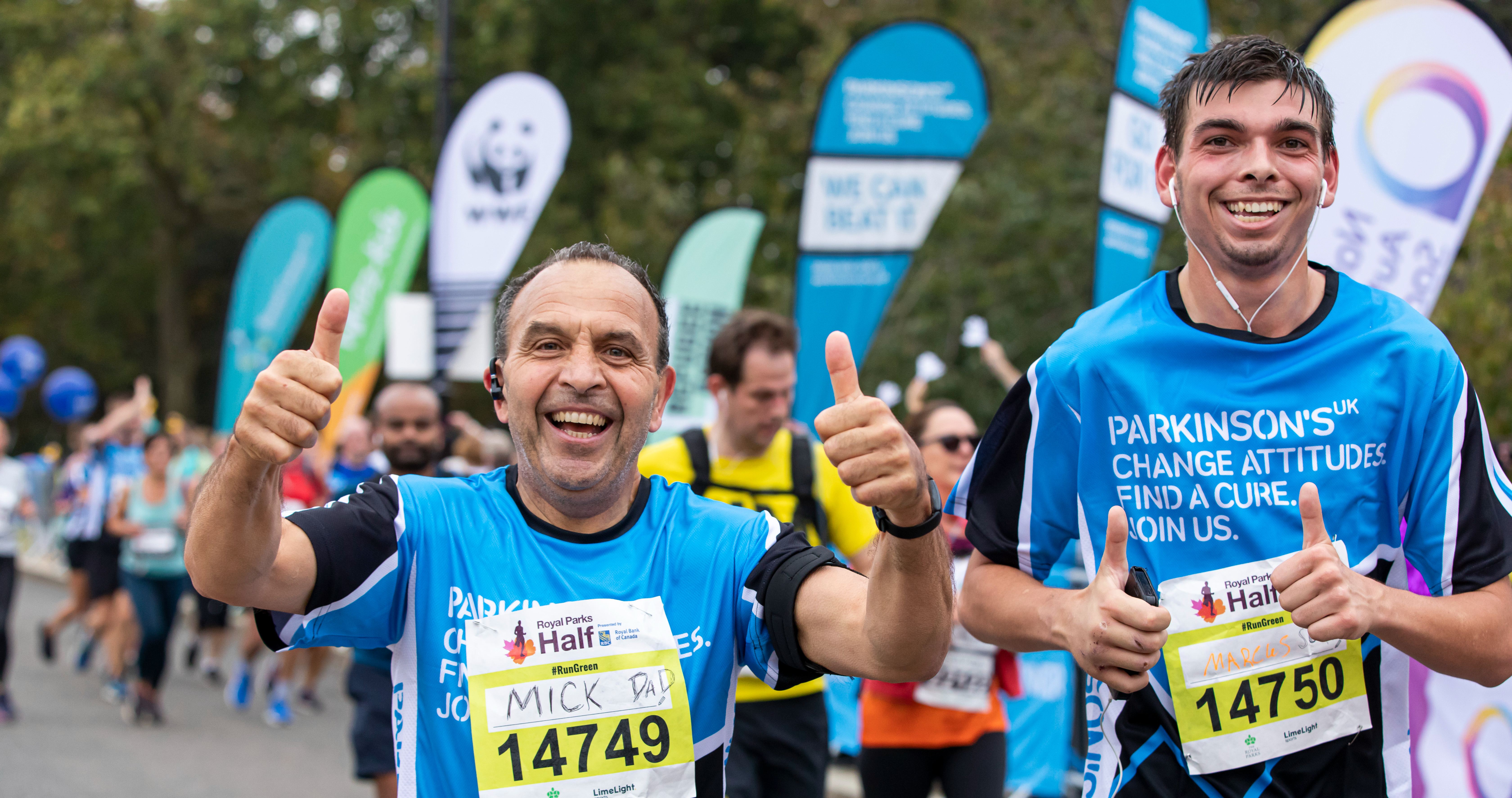 Mick and Marcus running the Royal Parks Half Marathon giving thumbs up to the camera