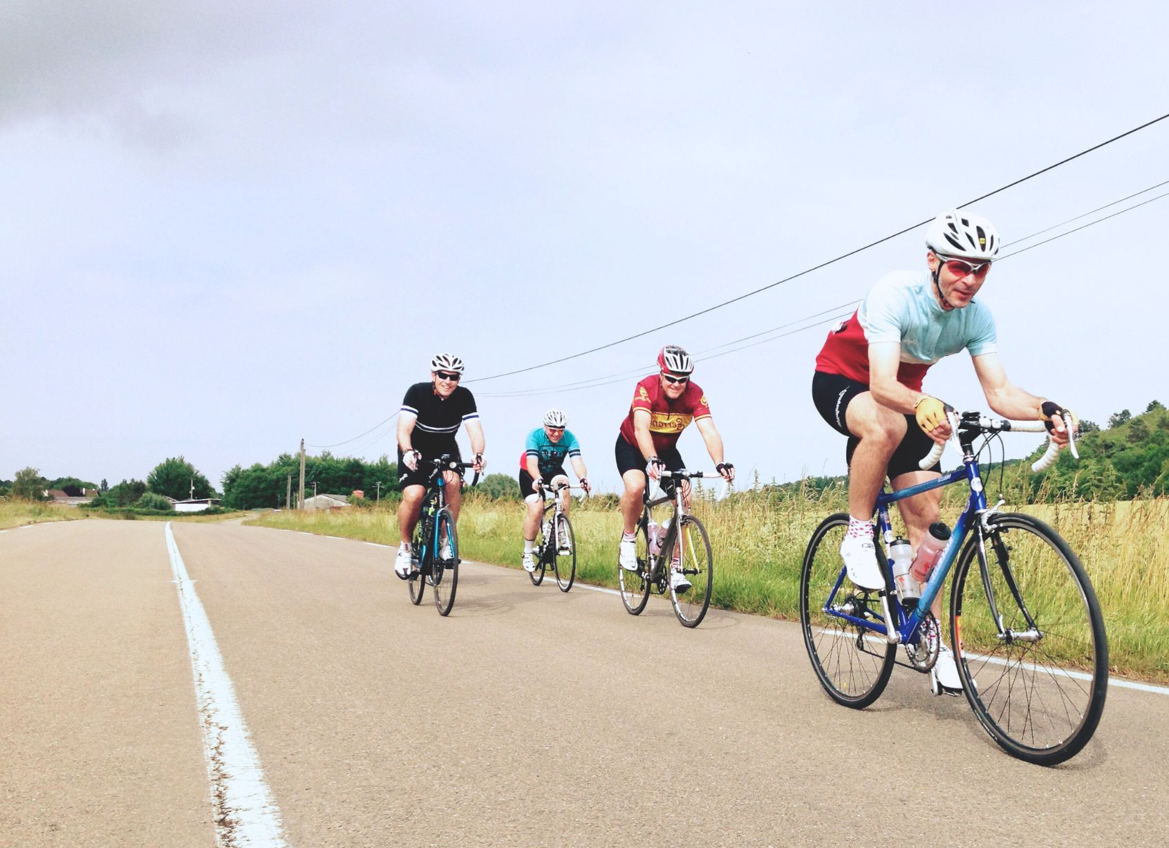 Four cylists on a country road
